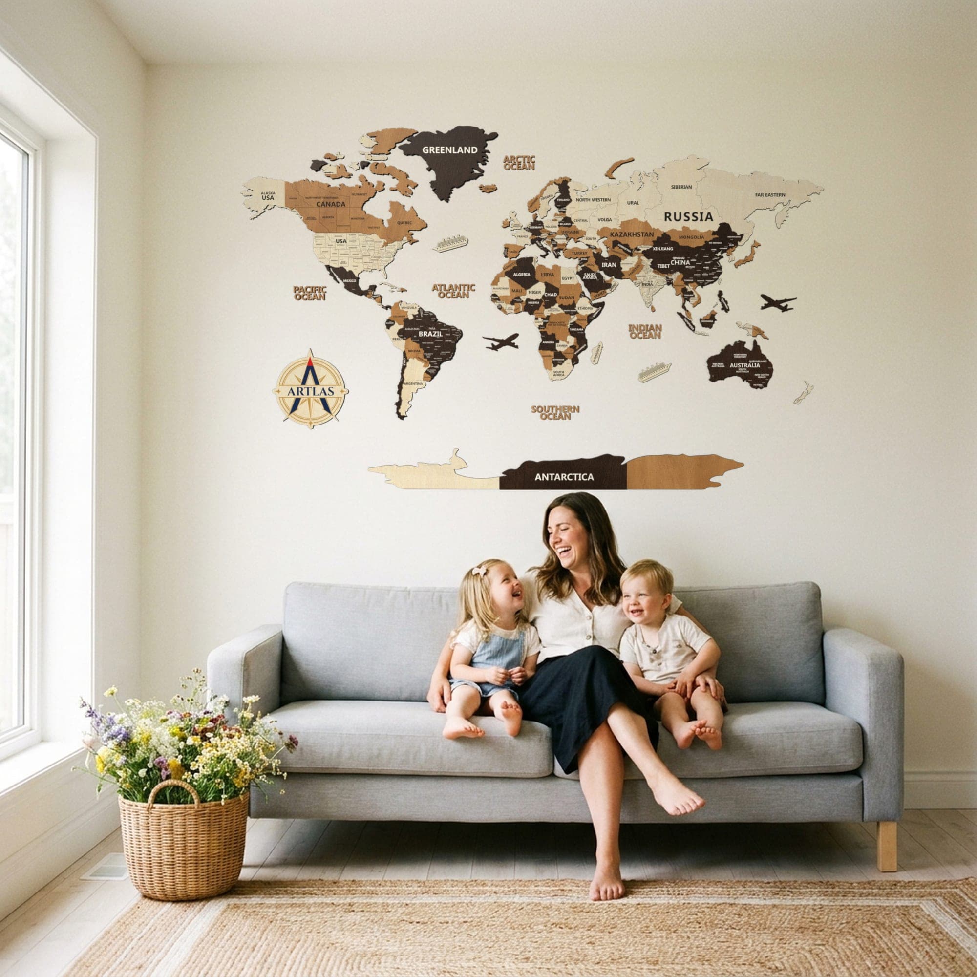 A family on a sofa beneath the map in birch, teak and walnut