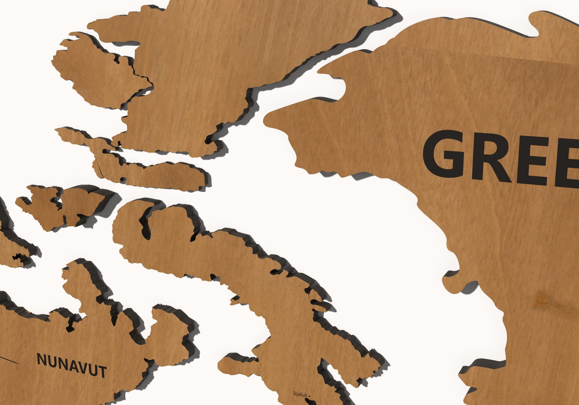 The layers of the map in teak close up — the cut edges and the shadow between them