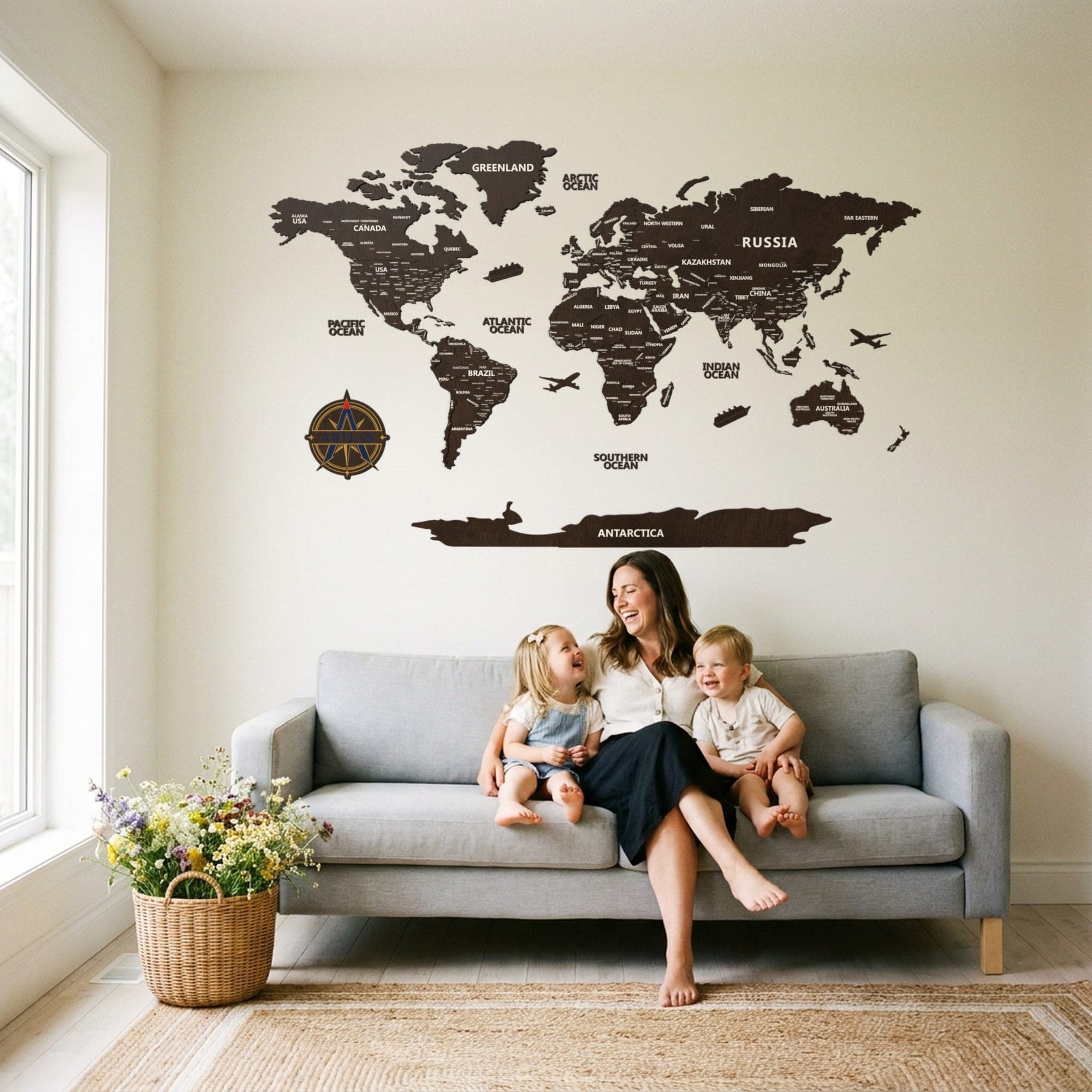 A family on a sofa beneath the map in walnut