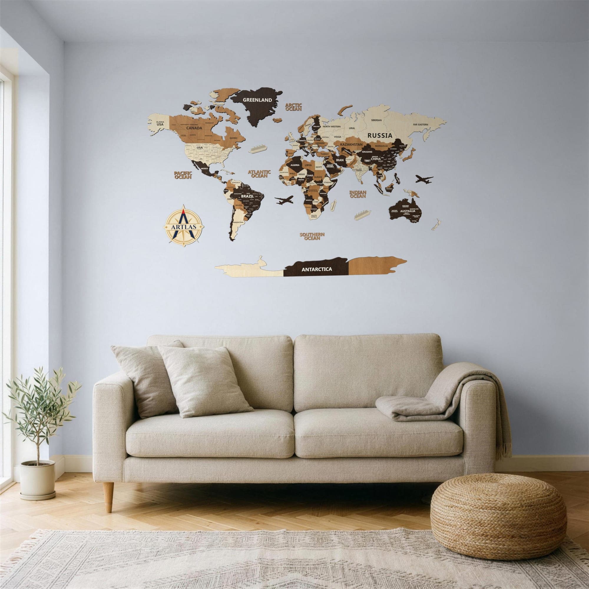 The Wooden World Map in birch, teak and walnut above a sofa